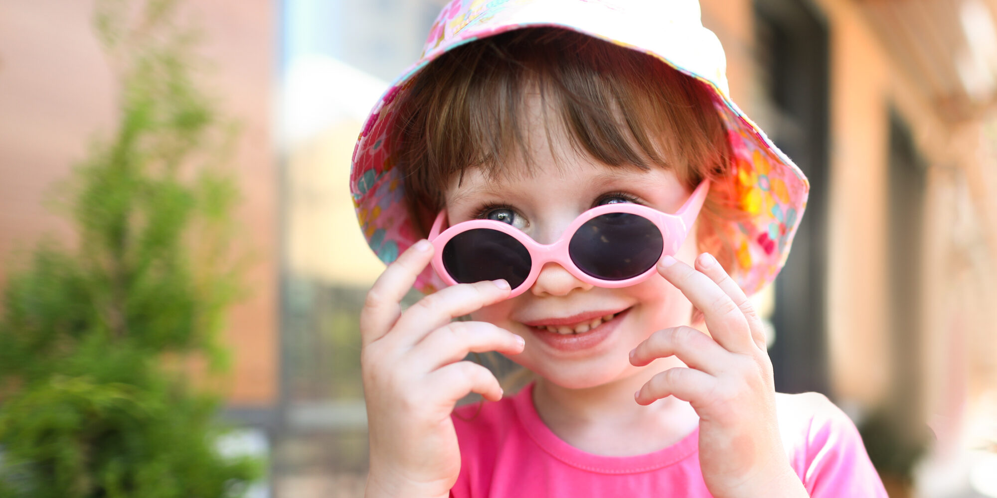 Happy smiling girl child in sunglasses outdoor portrait.
